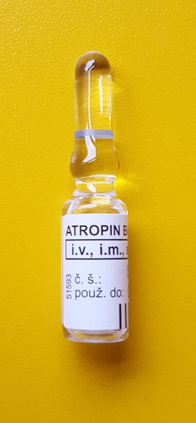Ampoule of atropine solution against a yellow background