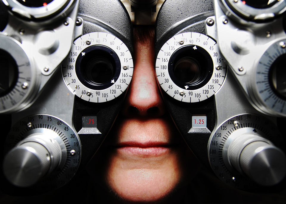 Close-up of a patient looking through a phoropter during an eye exam
