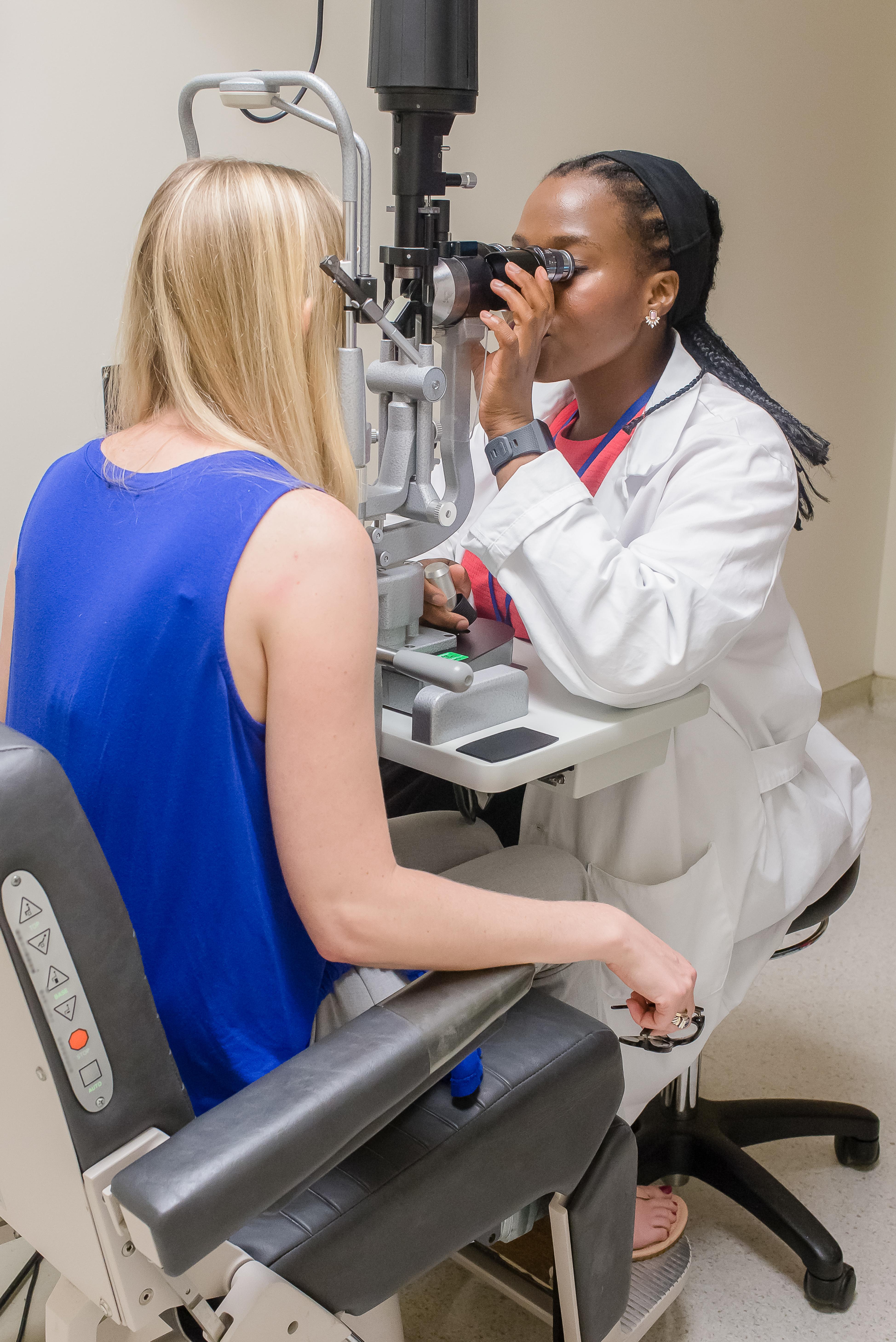 Ophthalmologist examining a patient with a slit-lamp microscope