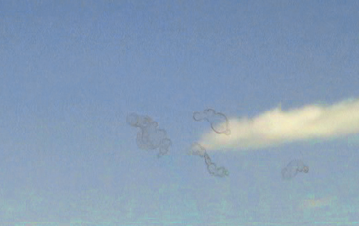 Simulation showing several wispy floaters drifting across a blue‑sky background.