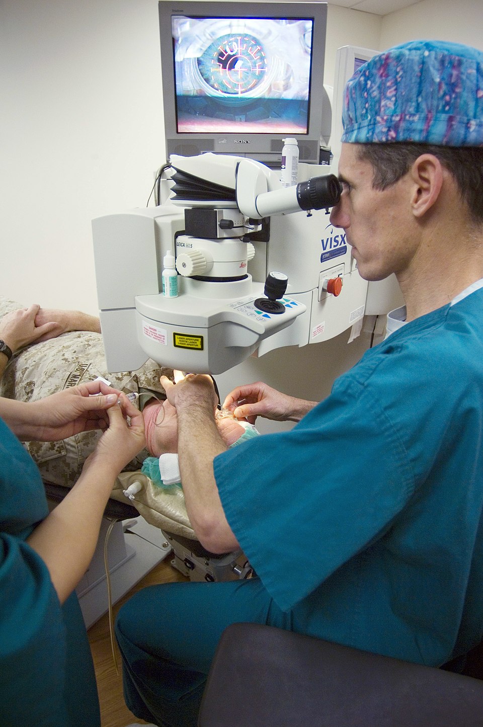 U.S. Navy surgeon positioning a VISX excimer laser for a LASIK procedure