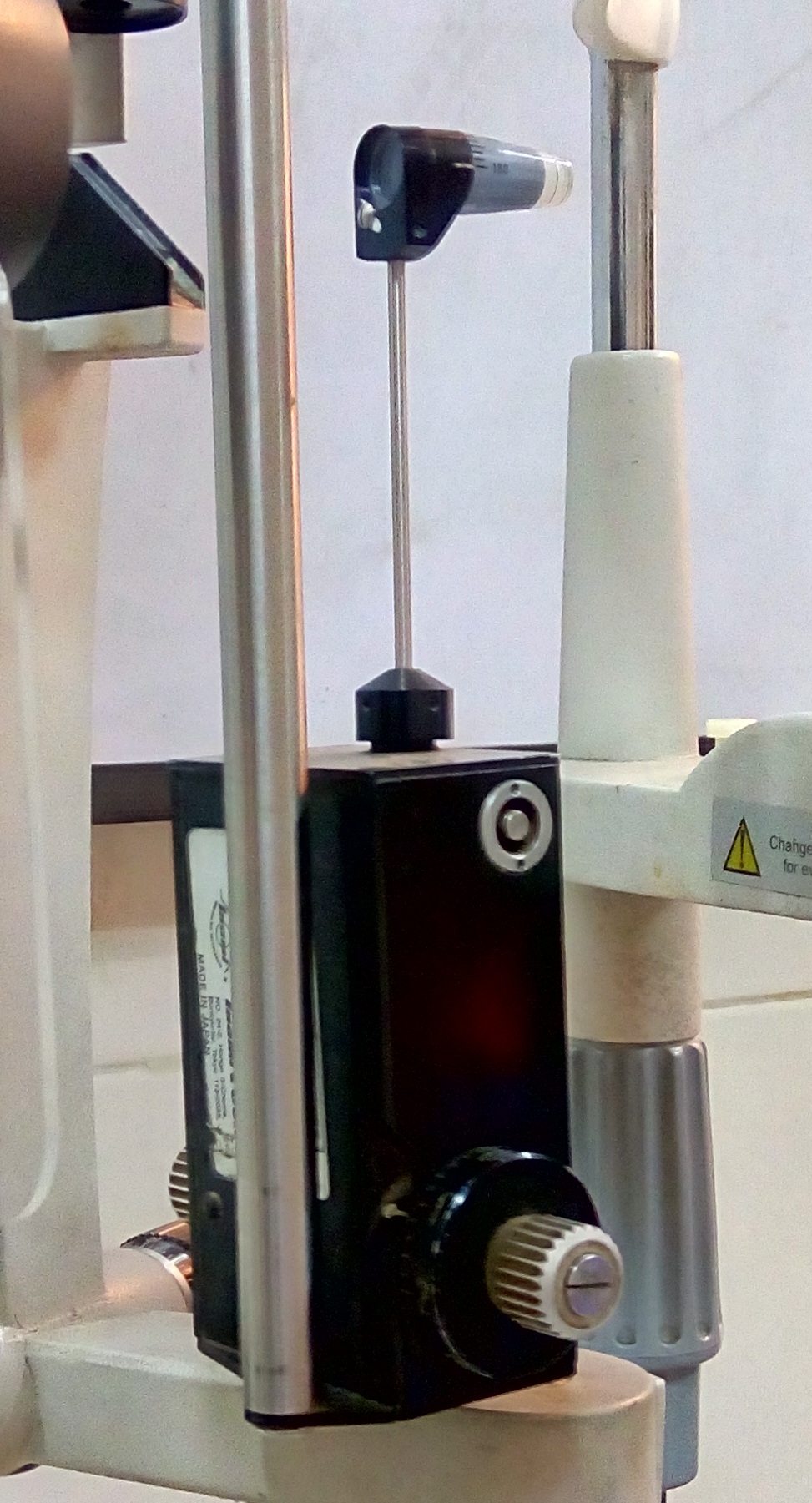 Goldmann applanation tonometer mounted on a slit-lamp microscope