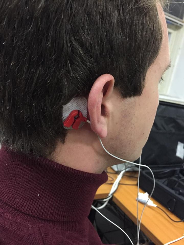 Electrode placed behind the ear during a visual evoked potential test.