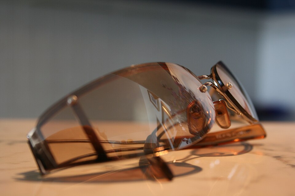 Brown-tinted wraparound sunglasses on a table.