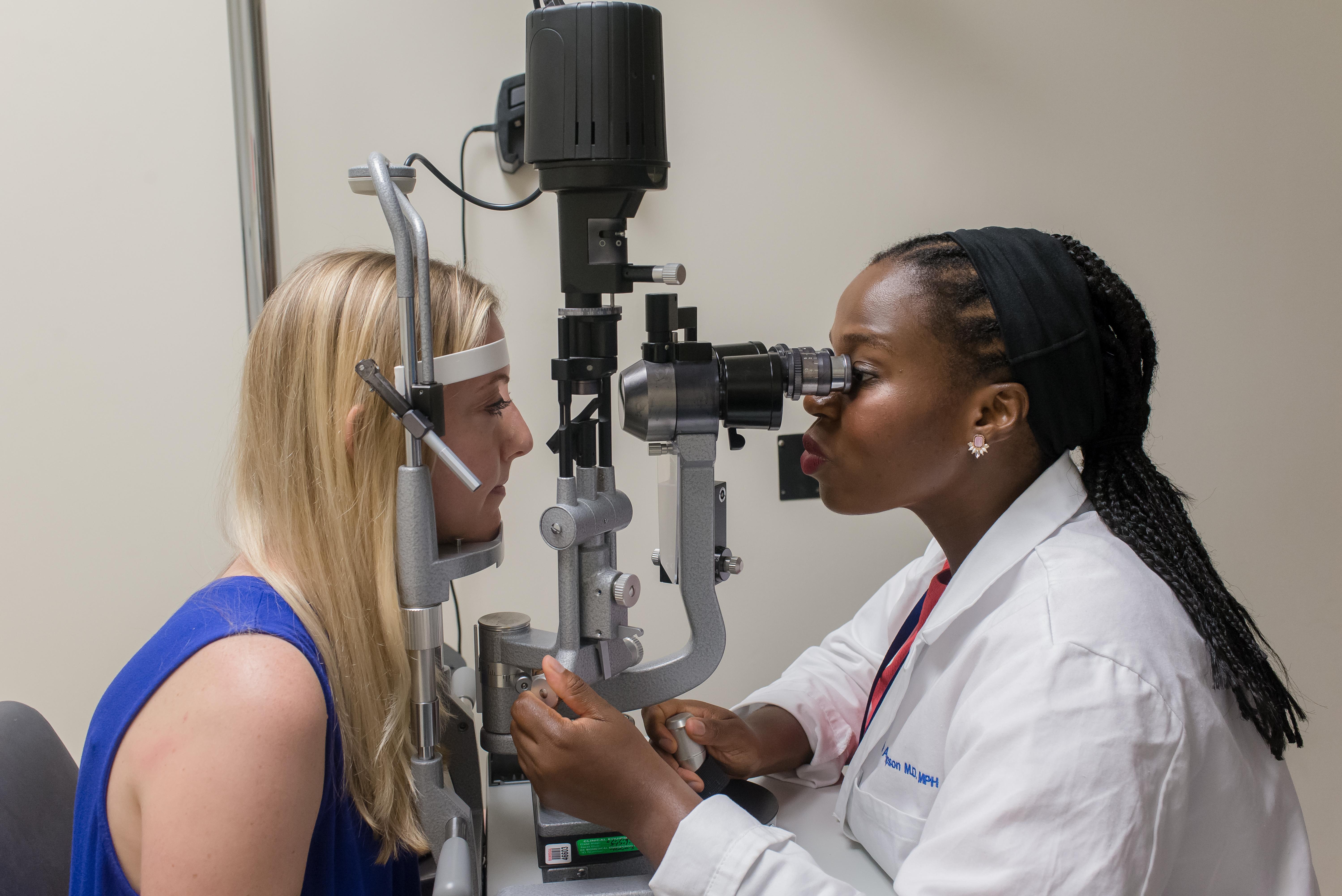 Ophthalmologist examining a patient’s eyes with a slit-lamp microscope